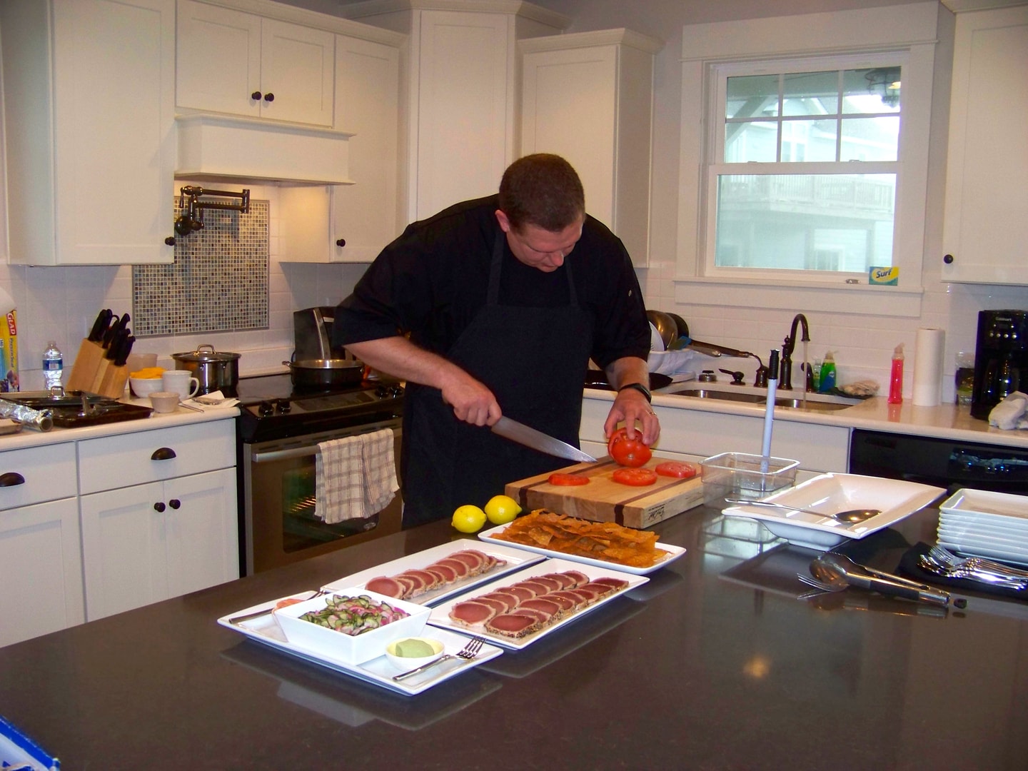 Private chef cooking in a vacation home kitchen